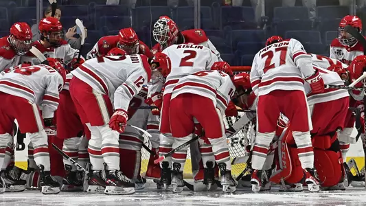 The Pios huddle in front of their goal ahead of their Dec. 6, 2022 game against Northeastern