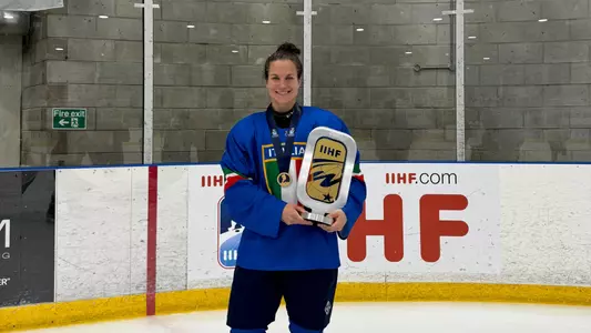 Verano holding trophy