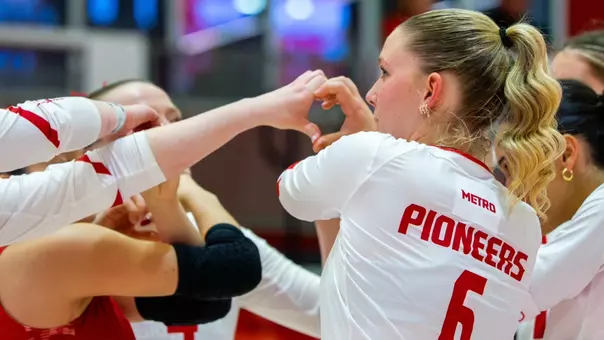 Volleyball Team Huddle with Addy Franz as the focus player