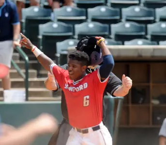 T.J. Dixon celebrates after scoring the game-winning run against Wofford in the SoCon Tournament.