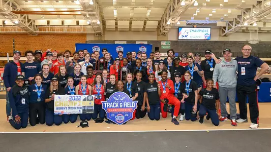 2022 Indoor Track and Field teams with SoCon trophies
