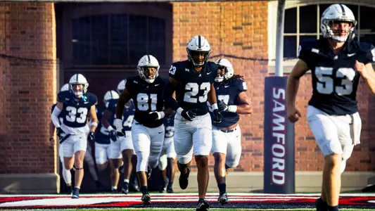 2024 football team running onto the field