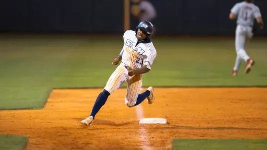 Michael Gupton rounding third base