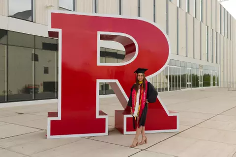 Graduate Yael Weber in front of the Block R at the APC