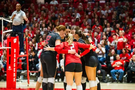 Rutgers volleyball huddles on the court at the UW Field House against No. 1 Wisconsin