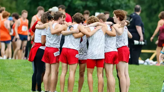 men's cross country team huddle