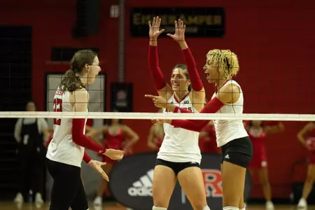 Alissa Kinkela, Alyssa Nayar and Rikki Williams celebrating during volleyball's match with No. 16 Minnesota at Jersey Mike's Arena