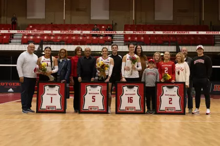 Rutgers seniors Chelsea Harvey, Alyssa Nayar, Kristina Grkovic and Madyson Chitty with their families and framed jerseys on senior night against Michigan State at the College Ave Gym
