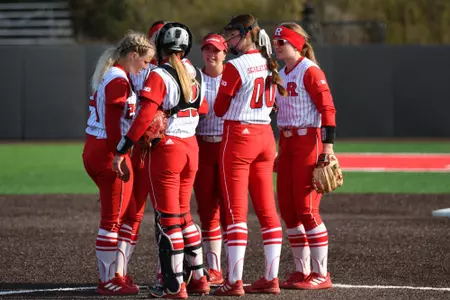 The Rutgers softball infield meets inside the circle during the series opener with Purdue