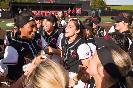 Jaden Vickers celebrates with her teammates after the Scarlet Knight tosses a complete game in the win over No. 18/19 Northwestern