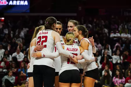 Rutgers volleyball huddles on the court during their contest with No. 16 Minnesota at Jersey Mike's Arena