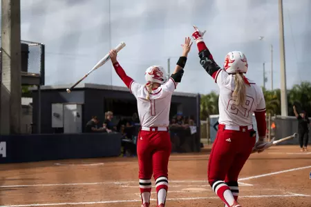 Jillian Anderson and Payton Lincavage celebrate Morgan Smith's home run versus No. 10 Duke at the Panther Invitational