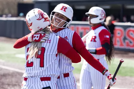 Kyleigh Sand hugs Payton Lincavage after scoring in the series finale against Ohio State at the RU Softball Complex