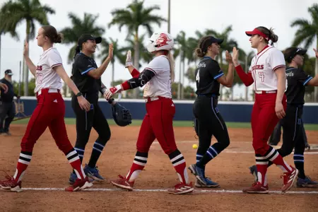 Laurelai DePew, Patyon Lincavage and Lauren Punk high five with No. 10 Duke following Rutgers softball's game with the Blue Devils at the Panther Invitaitonal