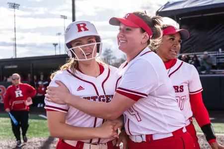 Katie Wingert celebrates with teammate Lauren Punk after collecting her school record 41st career home run against Nebraska at the RU Softball Complex