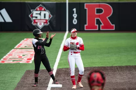 LA Matthews clapping after reaching third base in a 12-1 win over Wisconsin at the RU Softball Complex