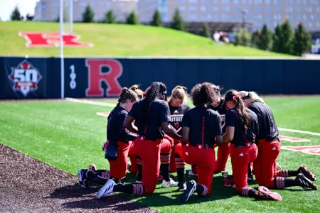Rutgers softball kneels before taking on Rider during the 2024 fall ball schedule