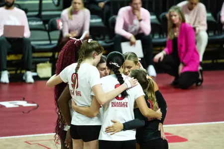 Rutgers volleyball huddles on the court during its match with Northwestern