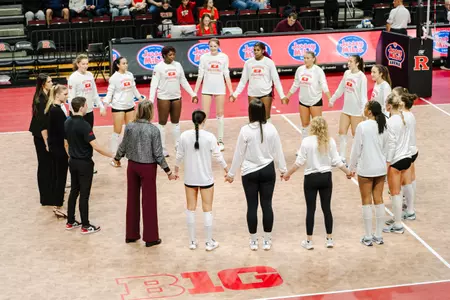 Rutgers volleyball circles pre-game on the court prior to its match against Illinois