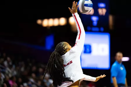 Zora Hardison serves against Michigan