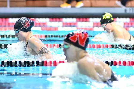 Molly Urkiel in front during the 100 breast against Iowa & Nebraska on Senior Day at the Rutgers Aquatics Center