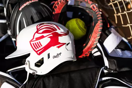 Rutgers softball helmet and ball in the dugout at the Spring Games