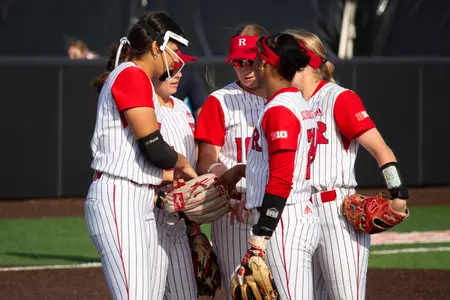 The infield meets inside the circle during Rutgers' Big Ten home opener with Maryland at the RU Softball Complex