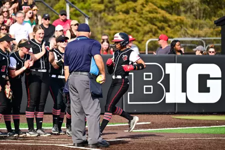 LA Matthews crossing the plate following a home run against No. 6 Oregon at the RU Softball Complex