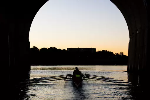 Rutgers Rowing goes underneath the Albany Street Bridge during 2025 fall practice on the Raritan River