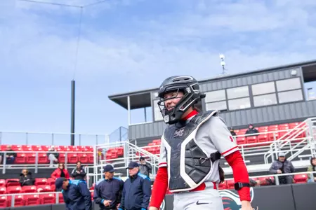 Charleigh Schuettler behind home plate at catcher during RU's home opener with FDU at the RU Softball Complex