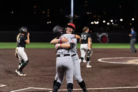 Stephanie Kraska hugs Riley Hwang following Kraska's walk-off hit in a 3-2 extra-inning win over Wagner at the RU Softball Complex