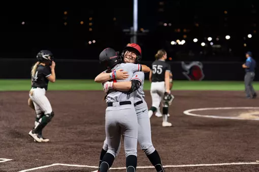 Stephanie Kraska hugs Riley Hwang following Kraska's walk-off hit in a 3-2 extra-inning win over Wagner at the RU Softball Complex