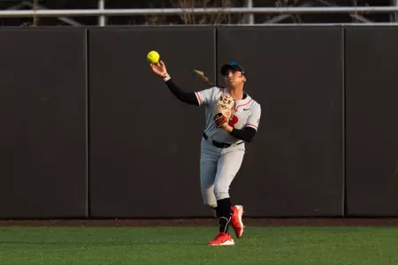 Rachel Millan in the outfield making a throw during the Wagner midweek game at the RU Softball Complex