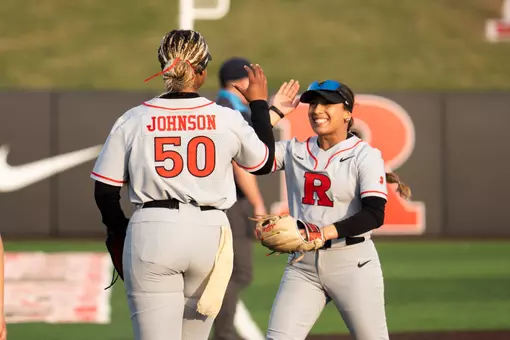 Rachel Millan high fives Dezaria Johnson during the Wagner game at the RU Softball Complex