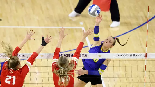 Sylvie Zgonc attacks the ball at the net against Denver blockers