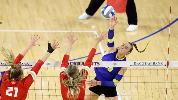 Sylvie Zgonc attacks the ball at the net against Denver blockers