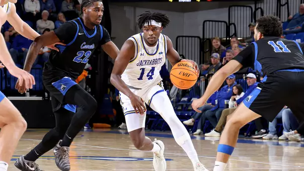 Jaden Jackson dribbling a basketball inside First Bank & Trust Arena