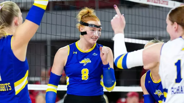 Madison Burr celebrates a point with her Jackrabbit teammates