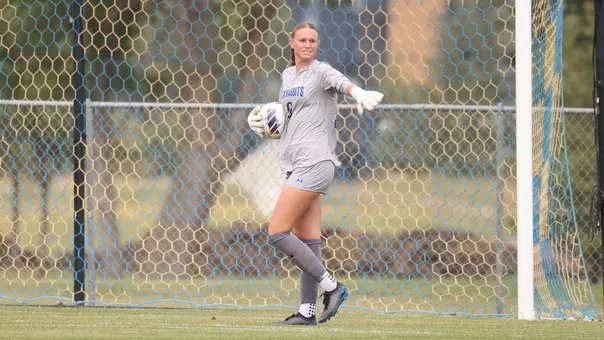 Mallorie Benhart holds the soccer ball and directs teammates on the field