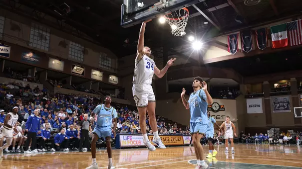 Damon Wilkinson shoots a layup towards a basketball hoop in a game on November 3, 2025