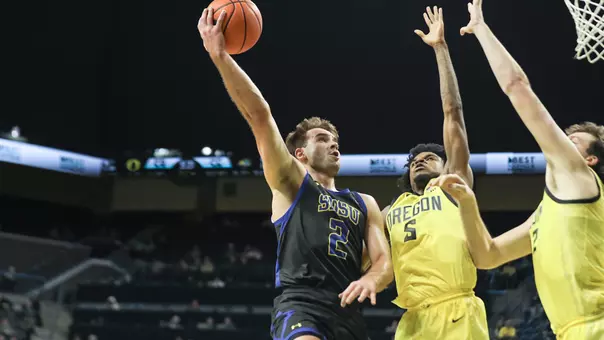 Luke Haertle shoots a layup against jumping defenders