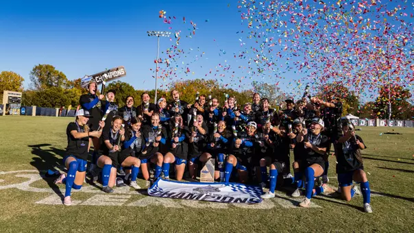 Soccer players celebrate on a soccer field