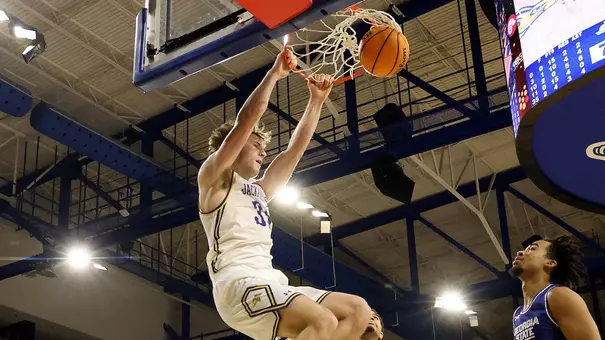 Alec Squires dunks a basketball