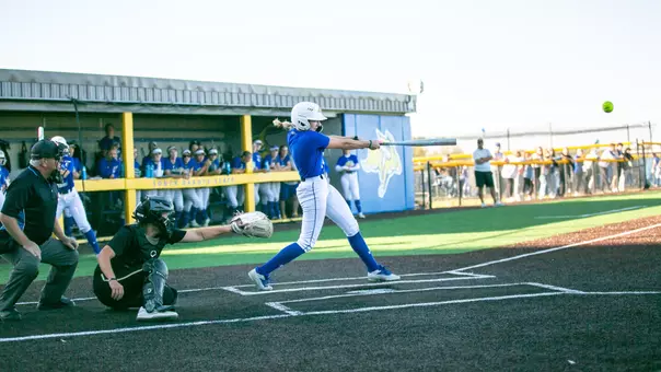 Bria Riebel hits a softball while in the batter's box