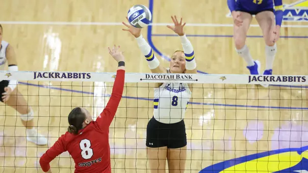Madison Burr defends an attacker at the volleyball next