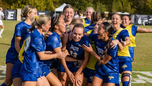 Lauren Walter is swarmed by her teammates as they celebrate a win