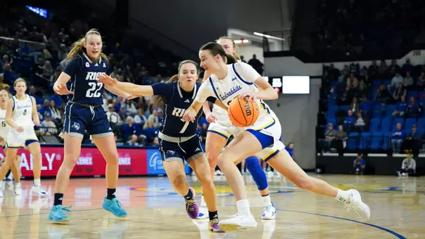 Katie Vasecka drives to the basket against two Rice defenders