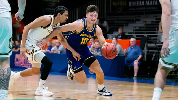 Kalen Garry dribbles a basketball in an SDSU game in Cancun, Mexico