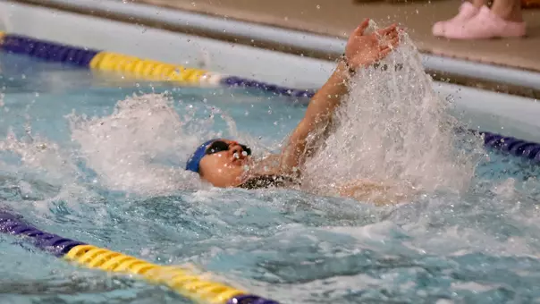 A South Dakota State women's swimmer competes in the backstroke.