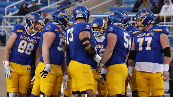 South Dakota State offensive players huddle before a play in a game against Illinois State.